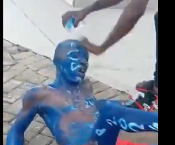 Video: Angry youth ordered a man who painted his body with NPP's trademark colours to wash it off